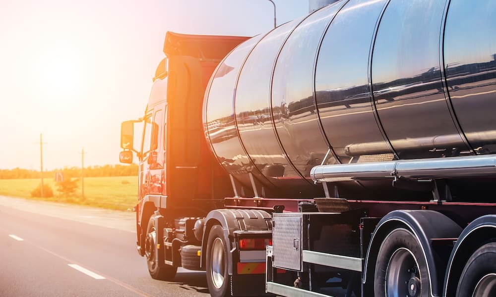Big gas-tank goes on highway against the sky